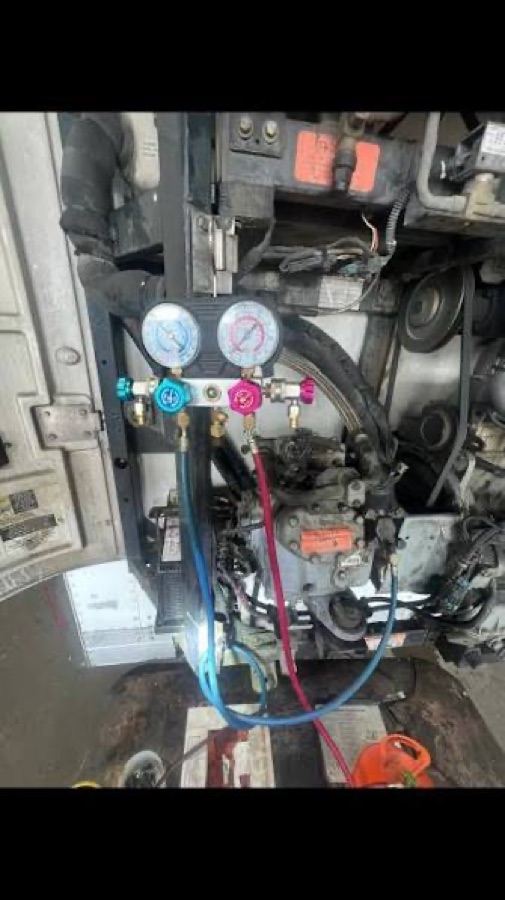 APU freon recharge gauges connected during truck-side service